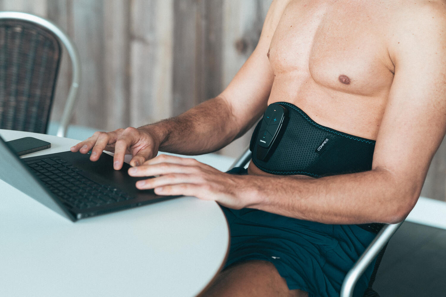 A person using the Core belt while working on his laptop